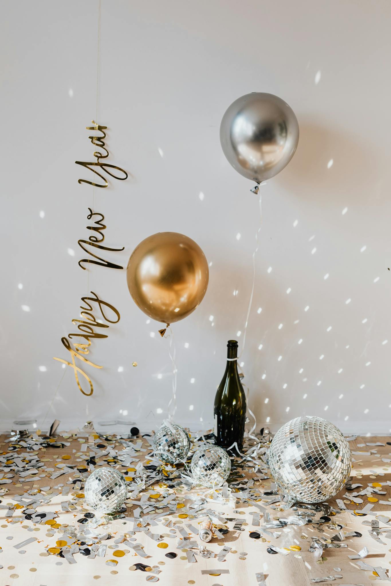 Elegant New Year's Eve scene with balloons, confetti, and disco balls, perfect for holiday celebrations.